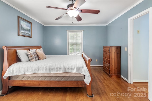 bedroom with wood-type flooring, ornamental molding, and ceiling fan