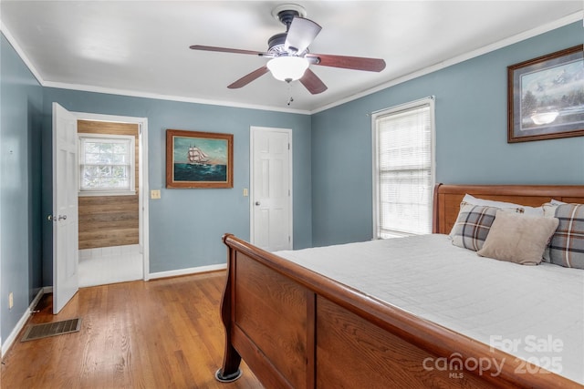 bedroom featuring crown molding, ceiling fan, and light hardwood / wood-style floors