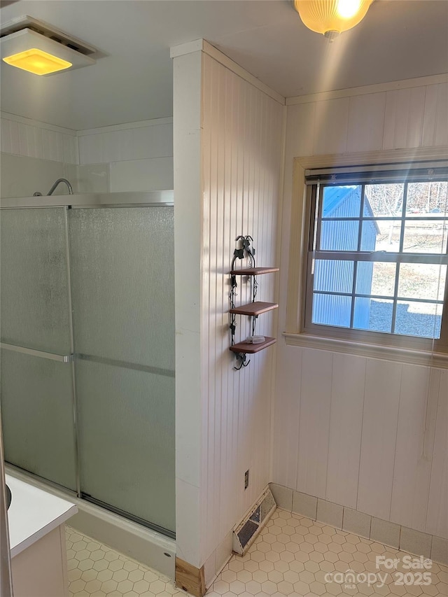 bathroom featuring tile patterned flooring and a shower with shower door