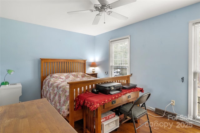 bedroom with hardwood / wood-style flooring and ceiling fan