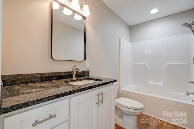 full bathroom featuring vanity, toilet, shower / bath combination, and hardwood / wood-style flooring