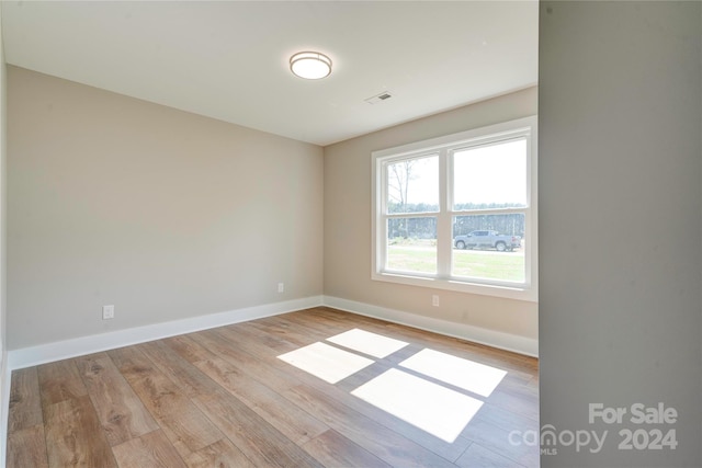 spare room featuring light wood-type flooring