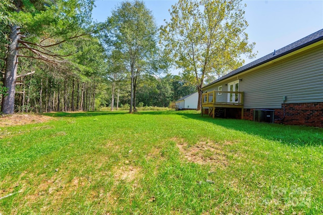 view of yard featuring a wooden deck and central AC unit