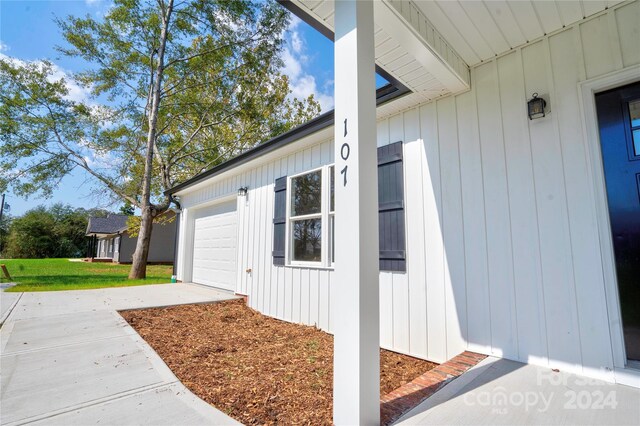 107 Falls St, Lawndale, NC 28090 - exterior space featuring board and batten siding, a yard, concrete driveway, and an attached garage