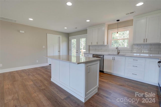 kitchen featuring white cabinets, dishwasher, wood-type flooring, and a healthy amount of sunlight