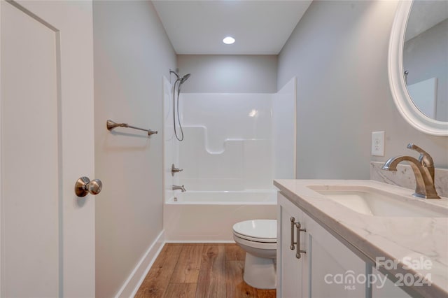 full bathroom with vanity, toilet, shower / washtub combination, and hardwood / wood-style flooring