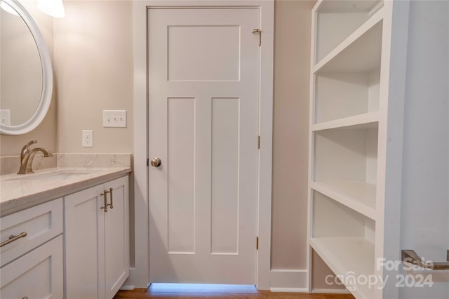 bathroom with vanity and hardwood / wood-style flooring