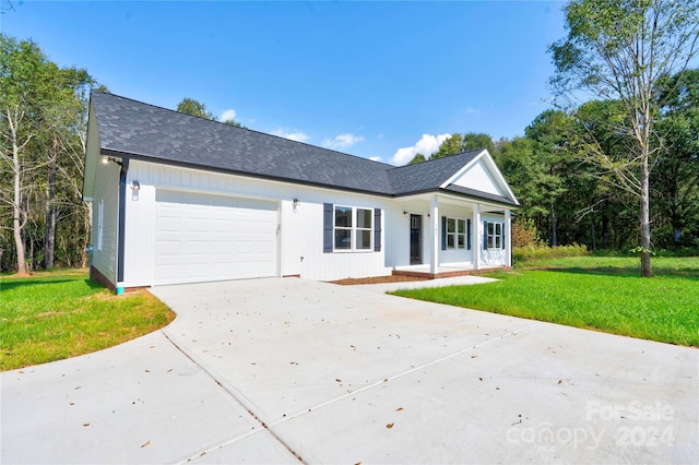 single story home with a garage and a front lawn