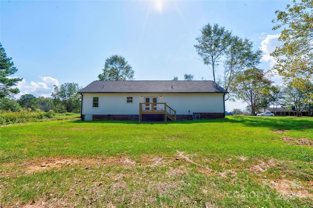 back of property with a lawn and central air condition unit