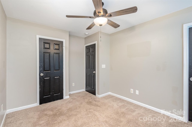 unfurnished bedroom with ceiling fan and light carpet