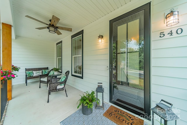 entrance to property with ceiling fan and a porch