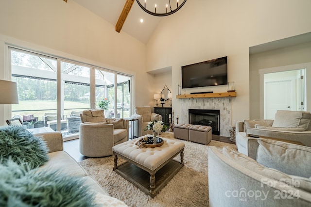 living room with a fireplace, a wealth of natural light, and beamed ceiling