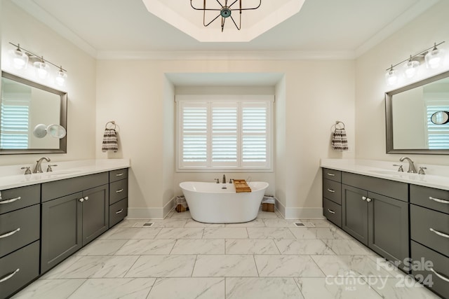 bathroom featuring vanity, crown molding, and a tub