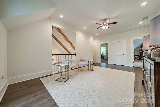 unfurnished room with lofted ceiling, crown molding, ceiling fan, and dark wood-type flooring