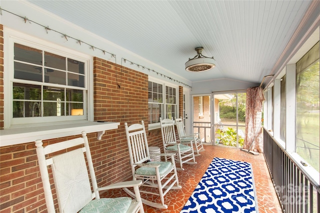 unfurnished sunroom featuring lofted ceiling