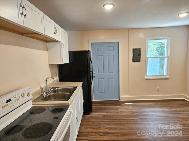 kitchen featuring white electric range oven, sink, dark hardwood / wood-style flooring, black fridge, and white cabinetry