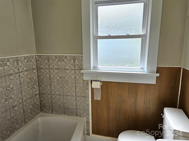 145 33rd St SW, Hickory, NC 28602 - full bathroom featuring toilet, a bath, a wainscoted wall, and wooden walls