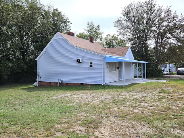 view of property exterior with a yard and a patio