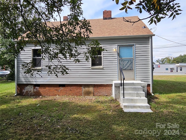 back of house with a yard