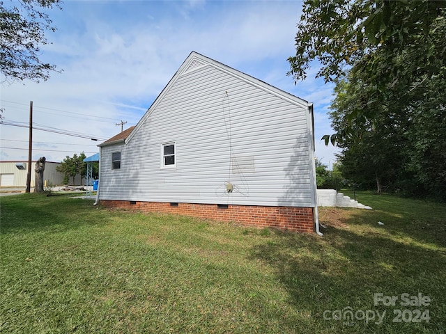 view of property exterior with a yard