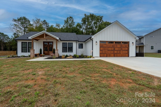 modern farmhouse style home featuring a garage and a front yard