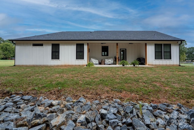 rear view of house with a patio and a yard