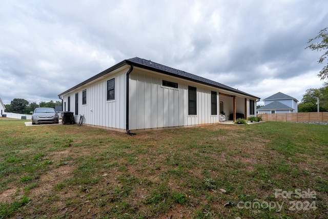 view of side of home with a yard