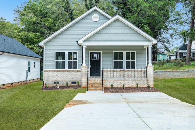 view of front of house with a porch and a front yard