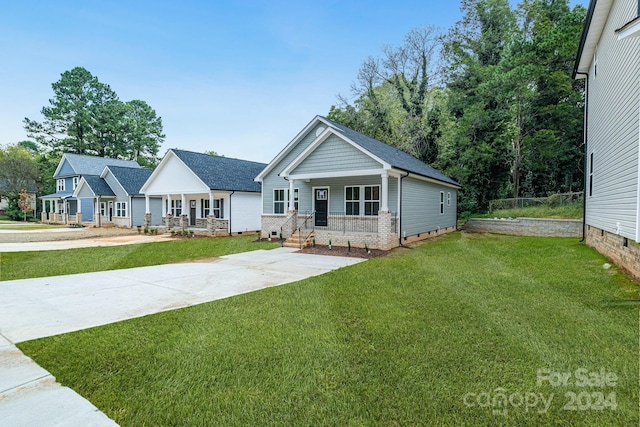 view of front of home with a front yard and a porch