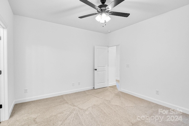 spare room with light carpet and ceiling fan