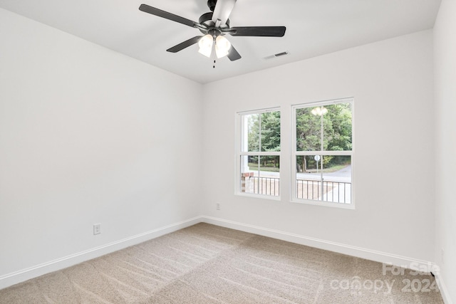 empty room featuring carpet and ceiling fan