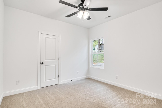 spare room with ceiling fan and carpet flooring