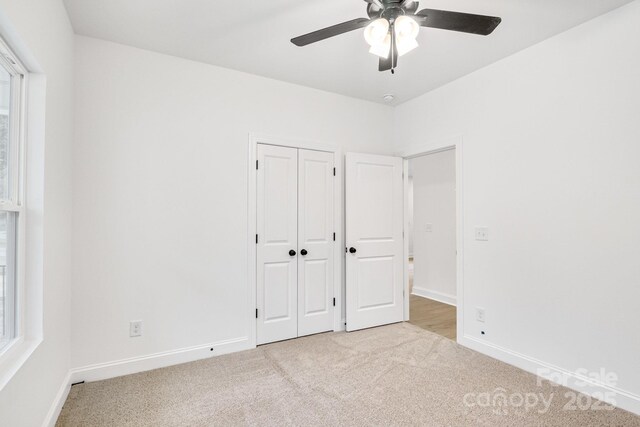 602 Meadow St, Spencer, NC 28159 - unfurnished bedroom featuring light colored carpet, a closet, and ceiling fan