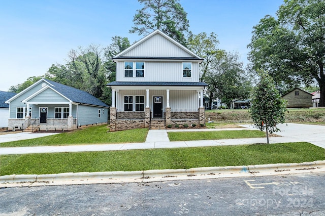 view of front of property with a porch and a front lawn