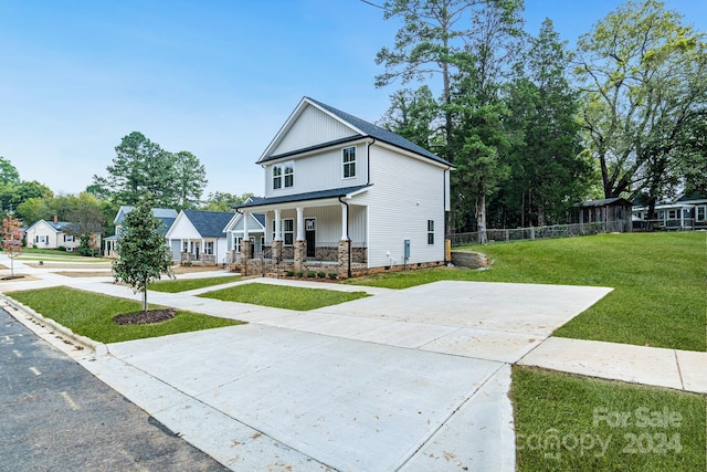 view of front facade with a front lawn and covered porch