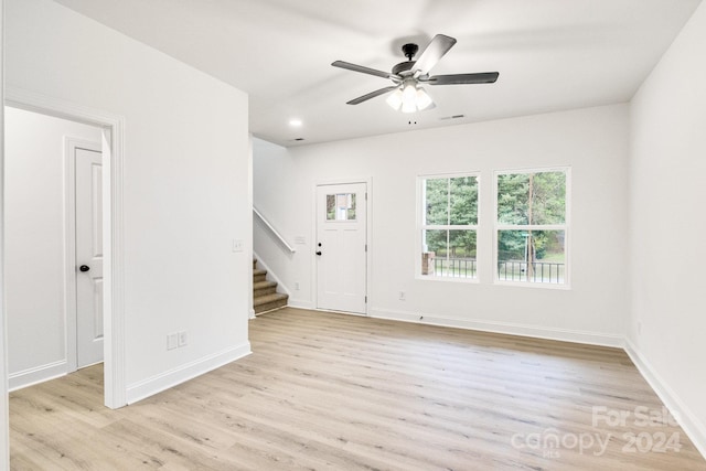 empty room with ceiling fan and light wood-type flooring