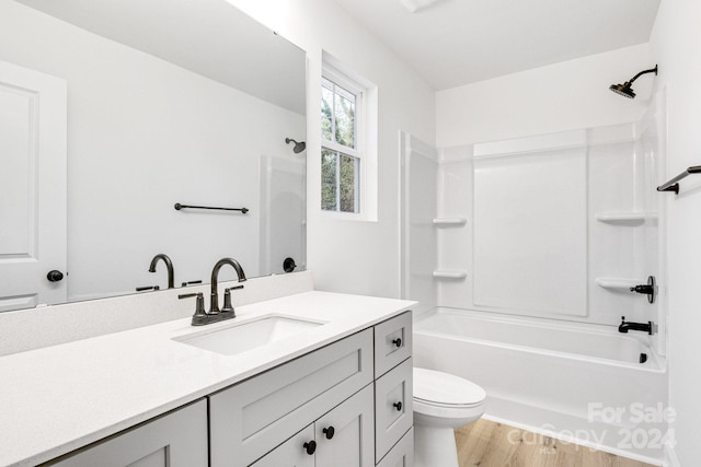 full bathroom featuring vanity, toilet, washtub / shower combination, and hardwood / wood-style flooring