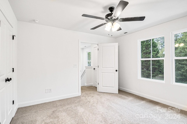 unfurnished bedroom featuring light carpet and ceiling fan