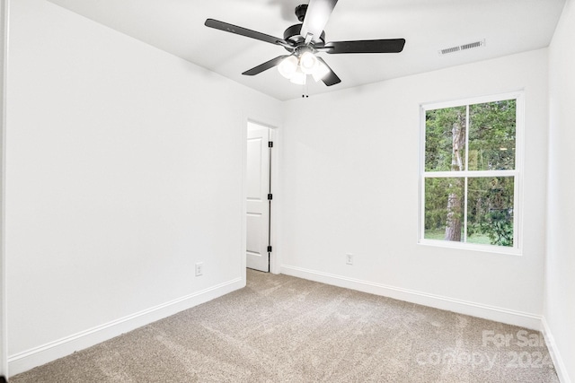 empty room with carpet floors and ceiling fan