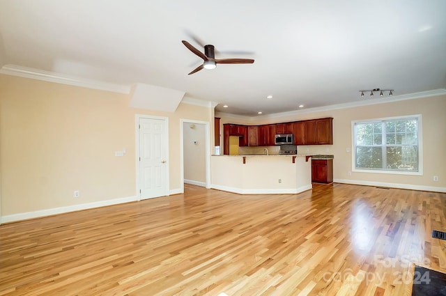 unfurnished living room featuring ornamental molding, light hardwood / wood-style flooring, and ceiling fan