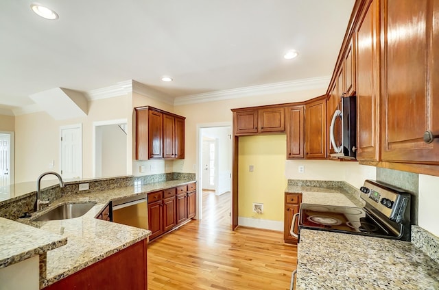 kitchen with light hardwood / wood-style floors, light stone counters, sink, ornamental molding, and appliances with stainless steel finishes