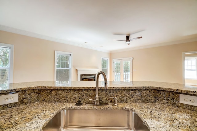 room details featuring ceiling fan, crown molding, sink, and stone countertops