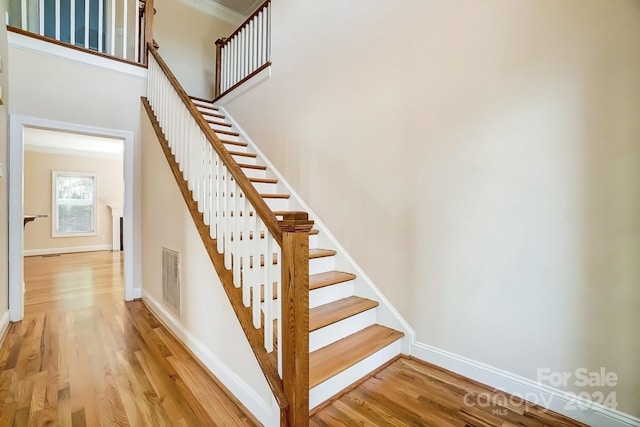 stairs featuring hardwood / wood-style floors