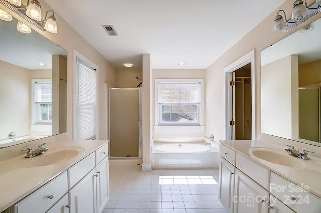 bathroom featuring independent shower and bath, vanity, and tile patterned floors