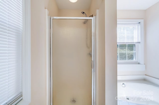 bathroom with a shower with shower door