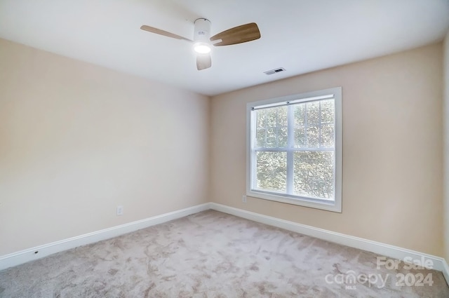 unfurnished room with ceiling fan and light colored carpet