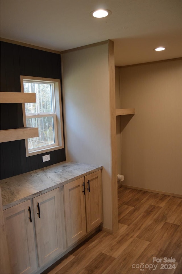 kitchen featuring light hardwood / wood-style floors and light brown cabinetry