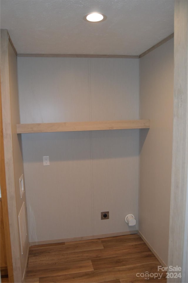 clothes washing area with hookup for an electric dryer and hardwood / wood-style flooring