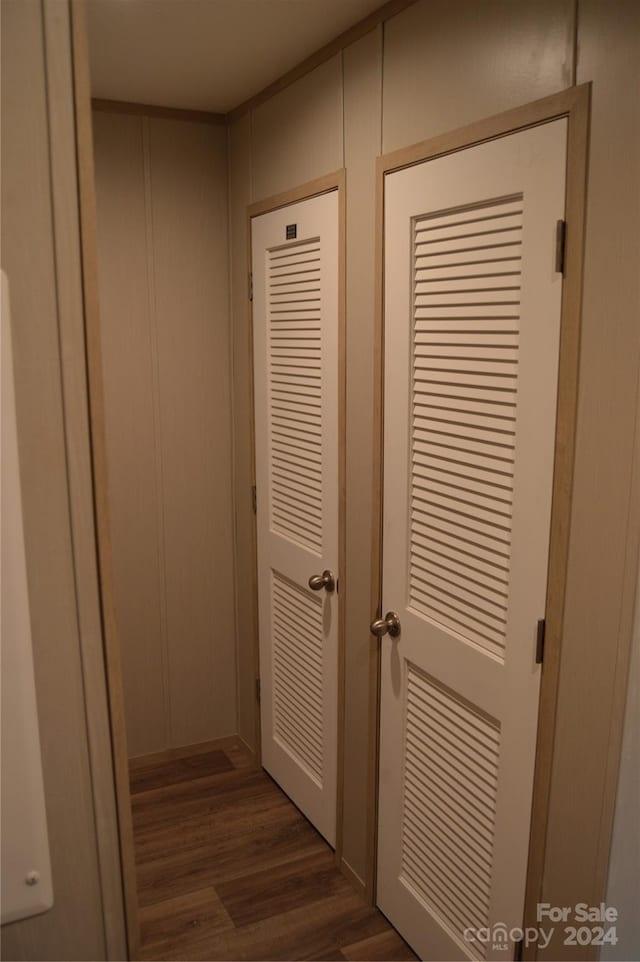 corridor featuring dark wood-type flooring