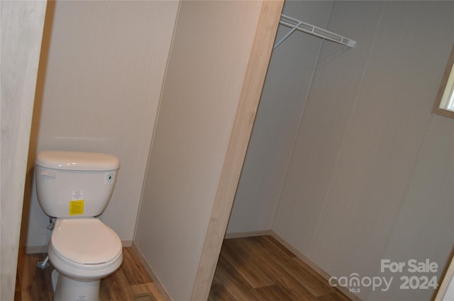 bathroom featuring hardwood / wood-style flooring and toilet